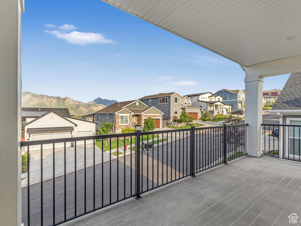 Balcony featuring a residential view and a mountain view