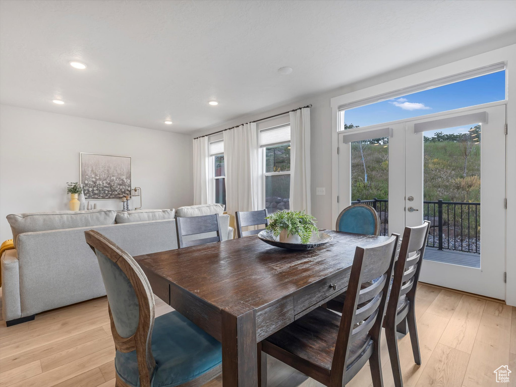 Dining area featuring light wood-style floors, recessed lighting, and french doors