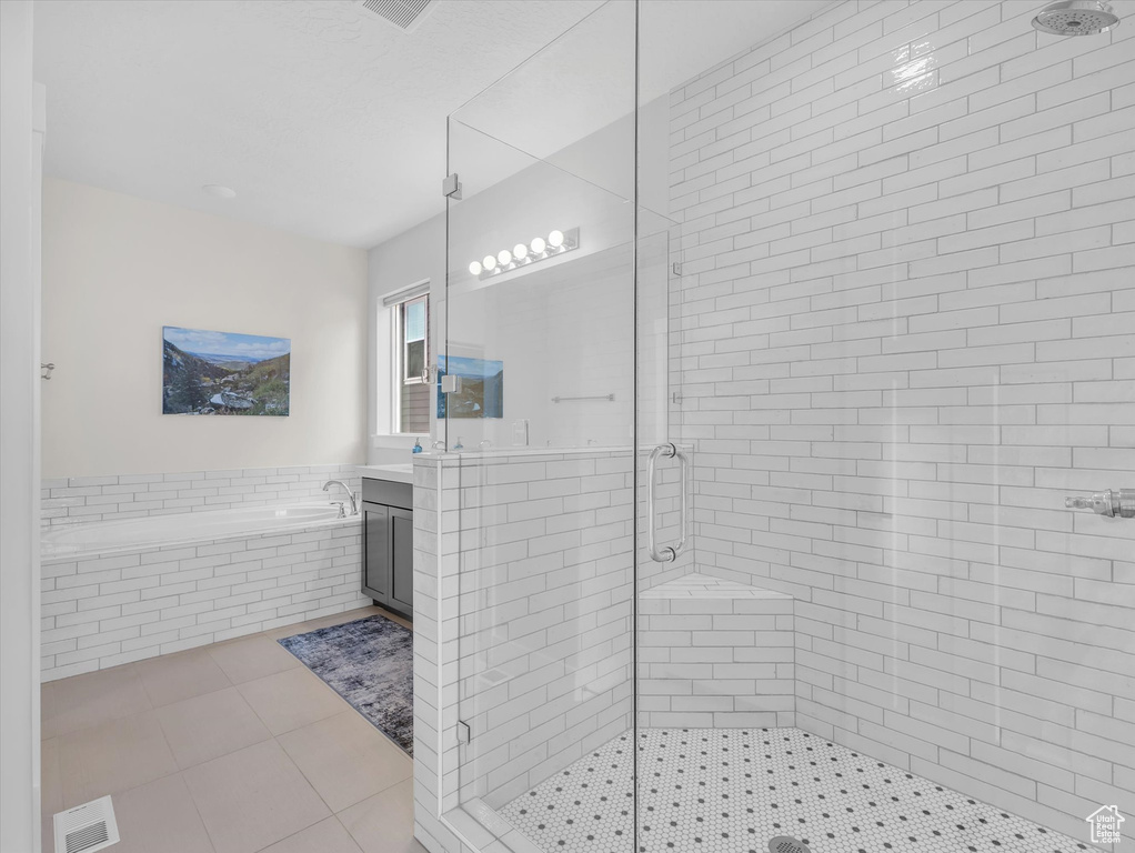 Bathroom with a garden tub, tile patterned flooring, visible vents, vanity, and a stall shower