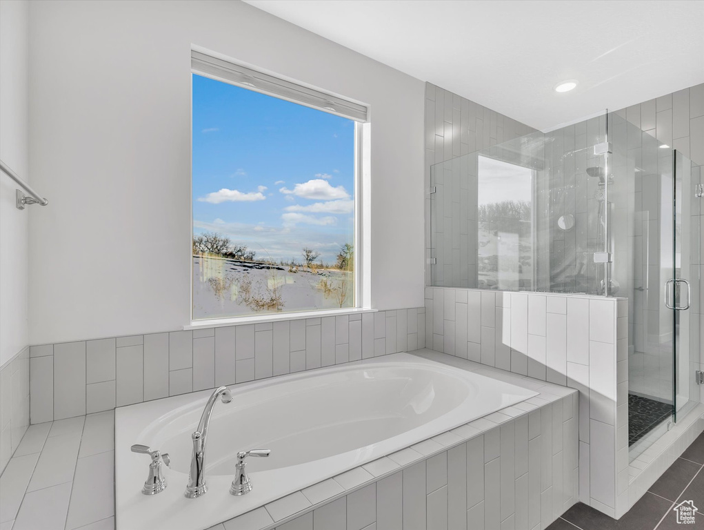 Bathroom featuring a garden tub, tile patterned floors, and a stall shower