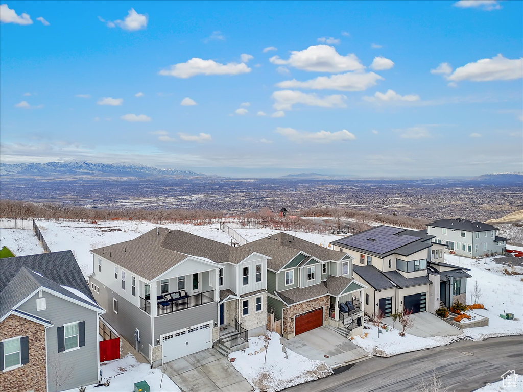 Snowy aerial view featuring a residential view and a mountain view