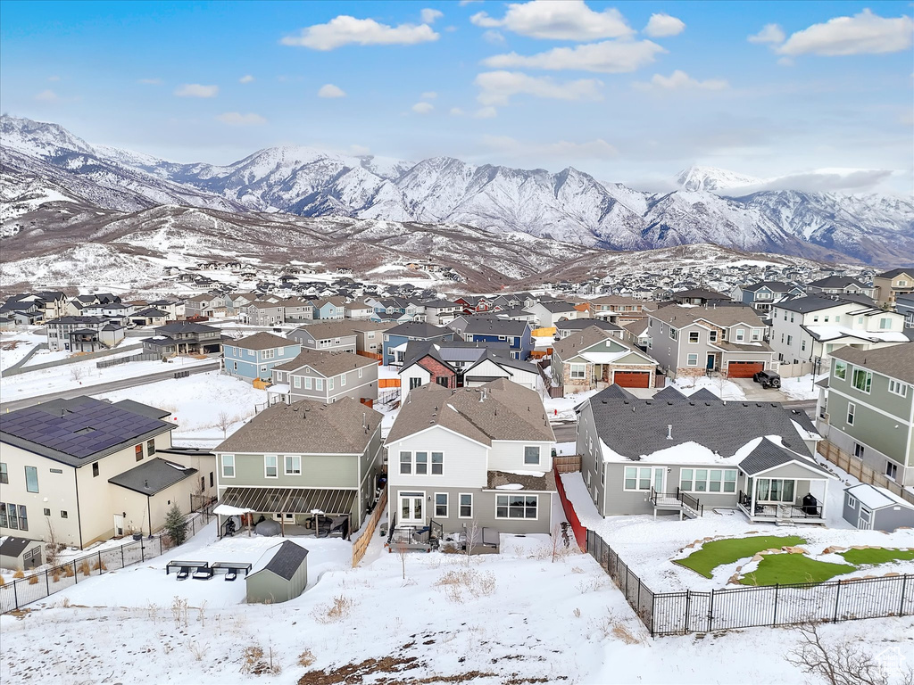 Snowy aerial view with a residential view and a mountain view