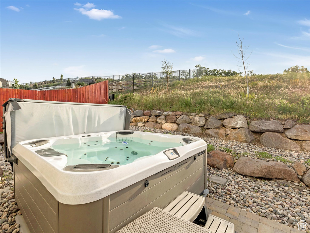 View of patio with a hot tub