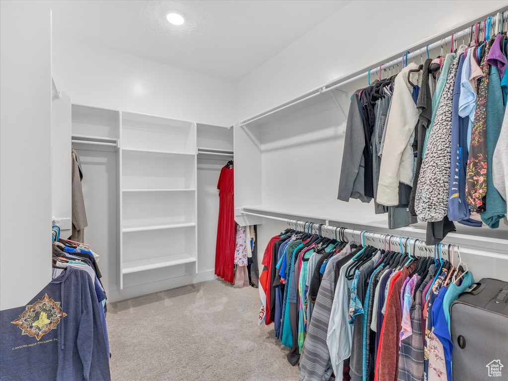 Walk in closet featuring light carpet