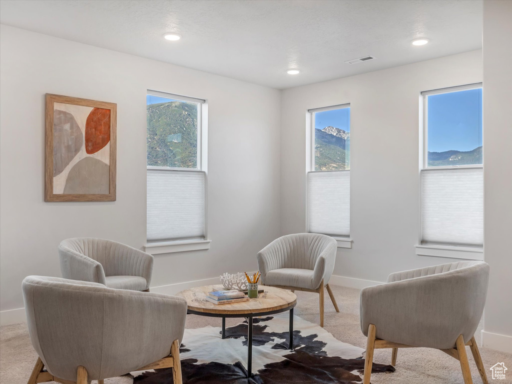 Living area with carpet floors, plenty of natural light, and recessed lighting