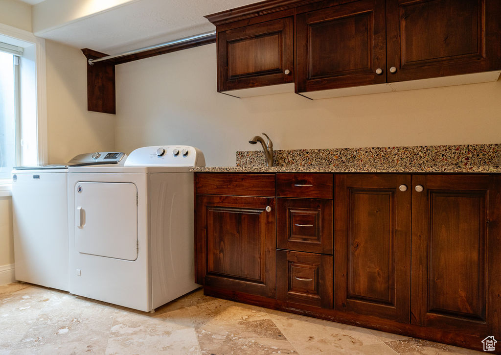 Laundry area with cabinets and washer and clothes dryer