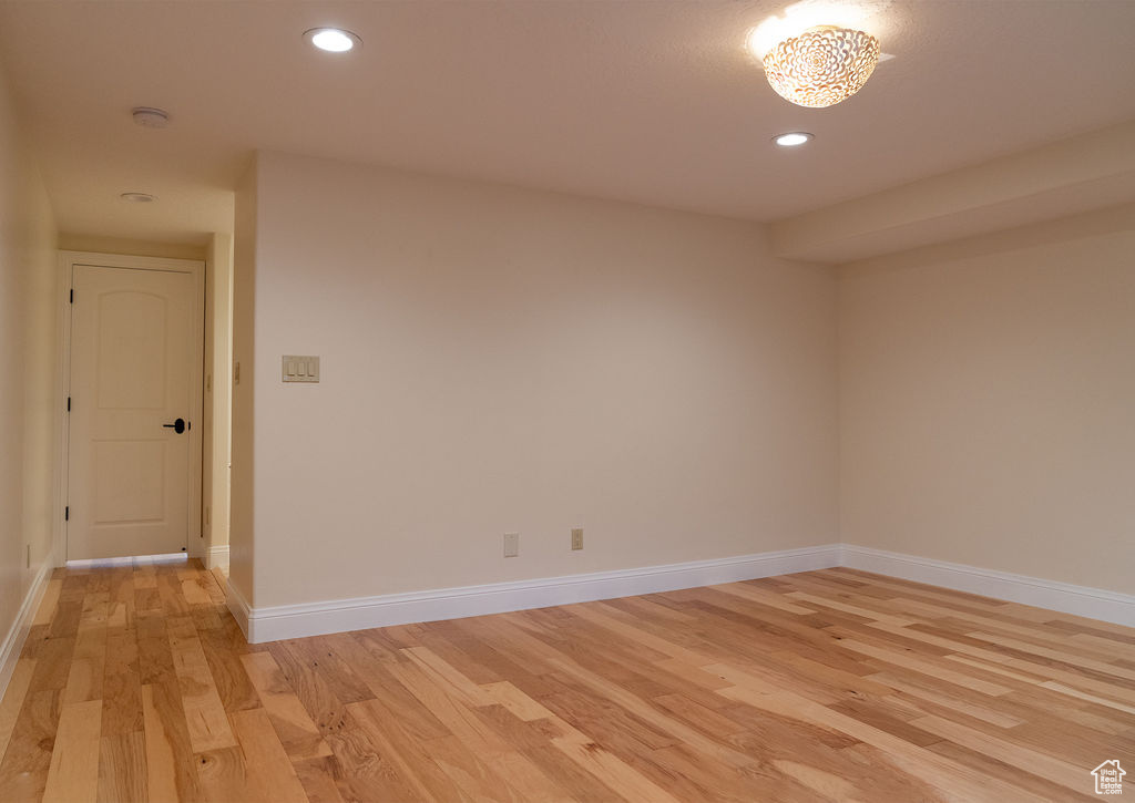 Empty room with light hardwood / wood-style floors