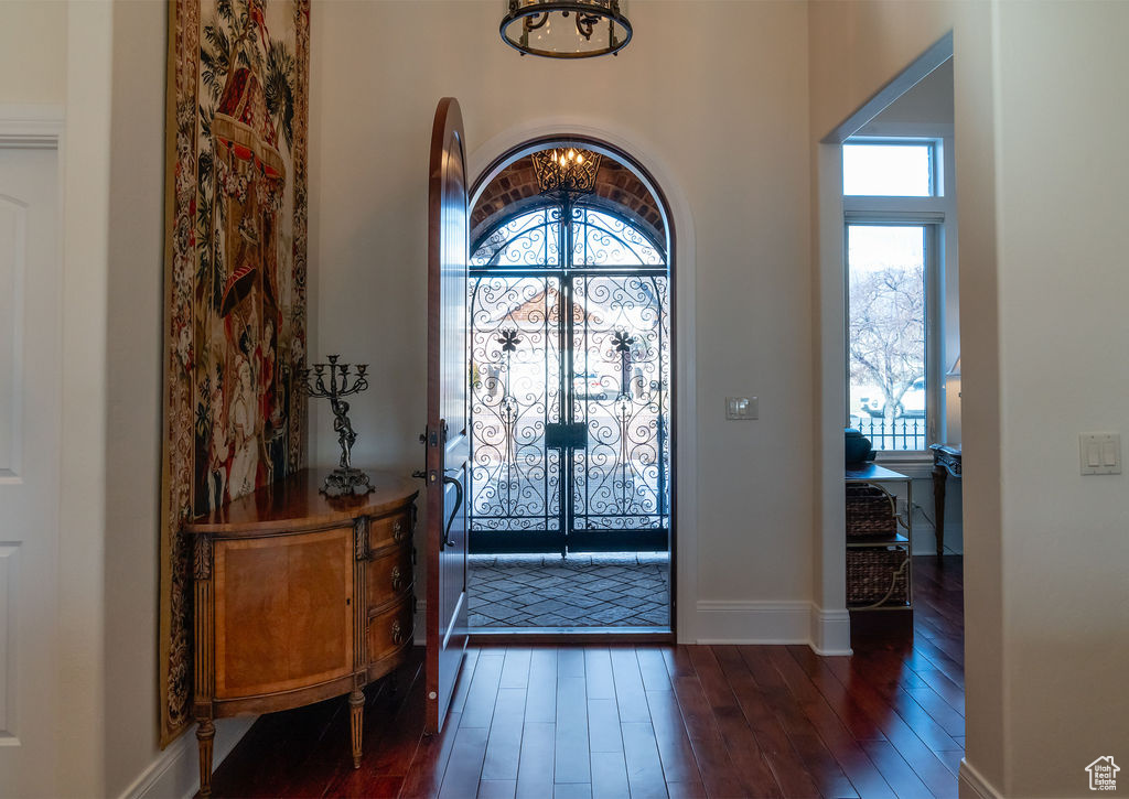 Entrance foyer featuring a chandelier and dark hardwood / wood-style flooring