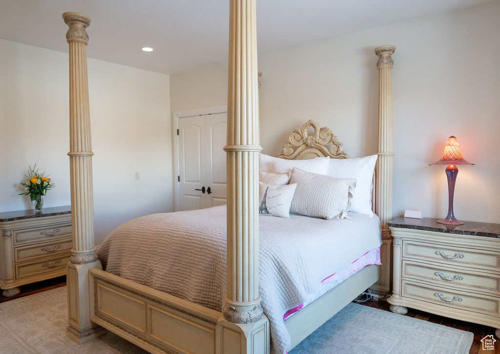 Bedroom featuring decorative columns and hardwood / wood-style floors