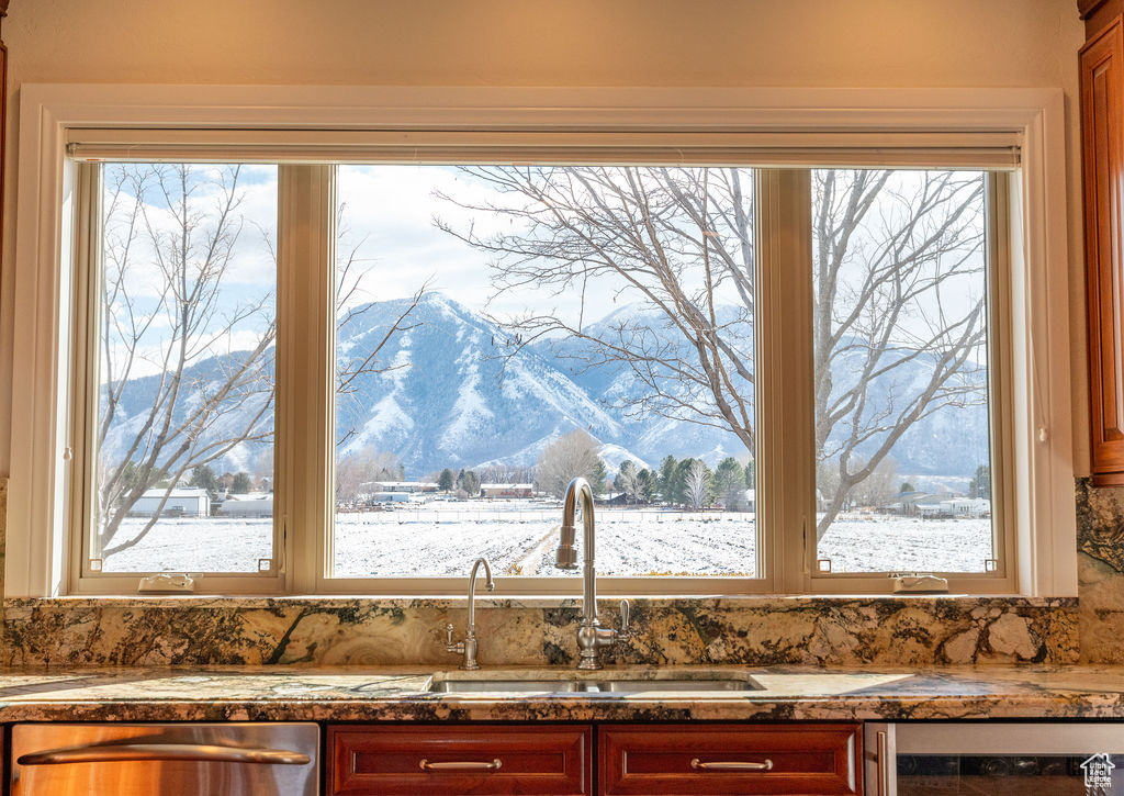 Kitchen with a mountain view, beverage cooler, a healthy amount of sunlight, and dishwasher