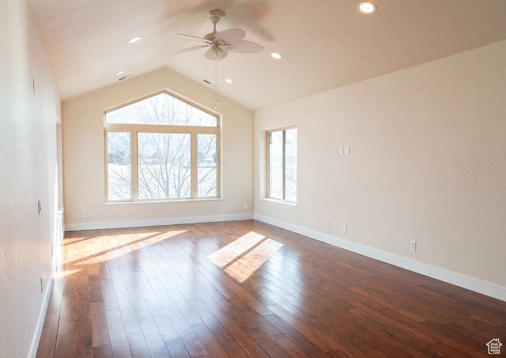Unfurnished room featuring vaulted ceiling, dark hardwood / wood-style floors, and ceiling fan