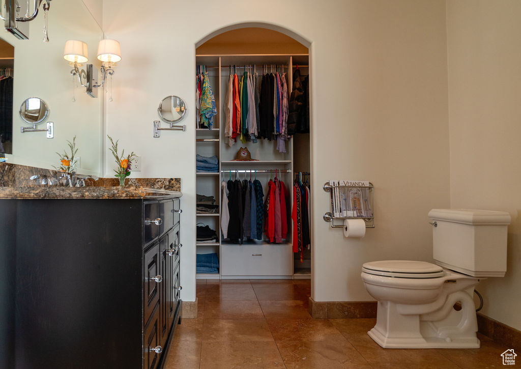 Bathroom featuring tile patterned floors, toilet, and vanity