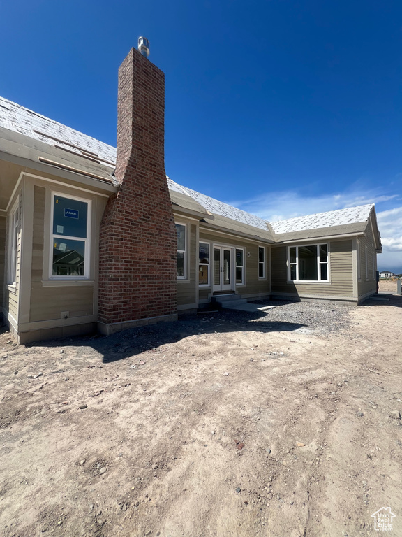 Rear view of property with french doors and a chimney