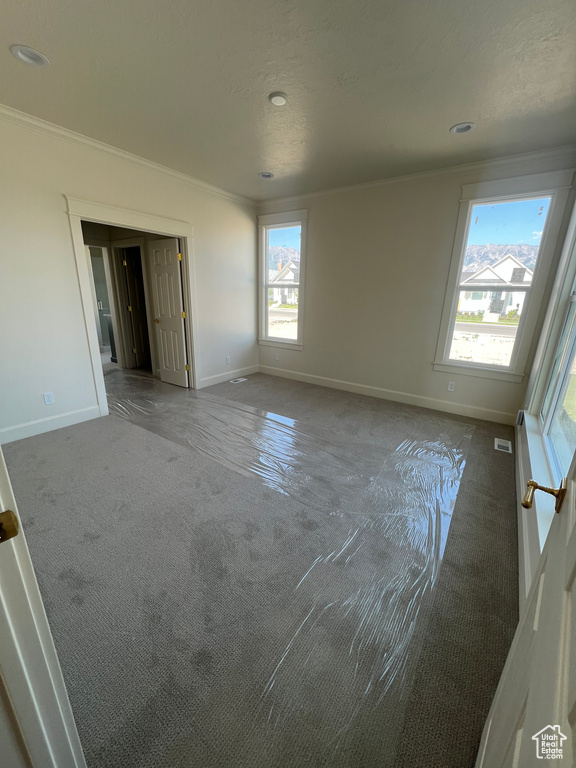 Unfurnished room with carpet flooring, crown molding, baseboards, and recessed lighting
