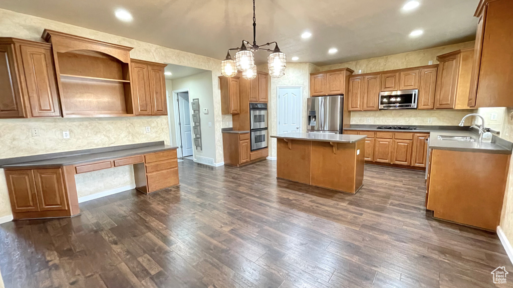 Kitchen featuring a sink, stainless steel appliances, a kitchen island, recessed lighting, and dark wood-type flooring