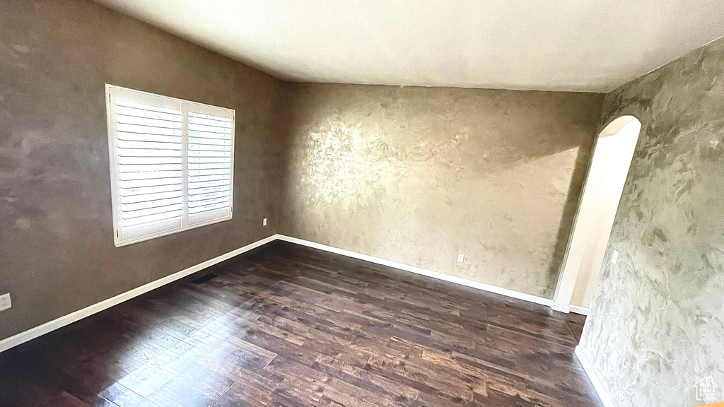 Unfurnished room with wood finished floors and baseboards