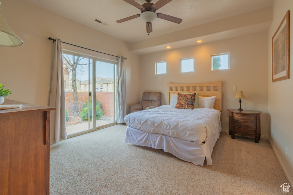 Bedroom featuring light colored carpet, access to outside, visible vents, and multiple windows