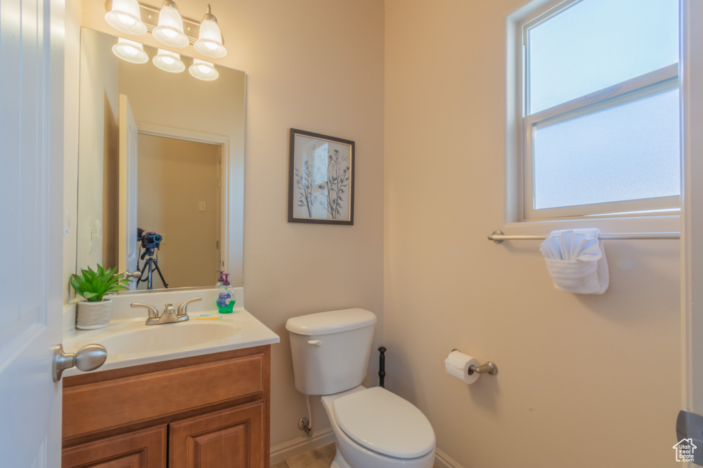 Half bathroom with vanity and toilet