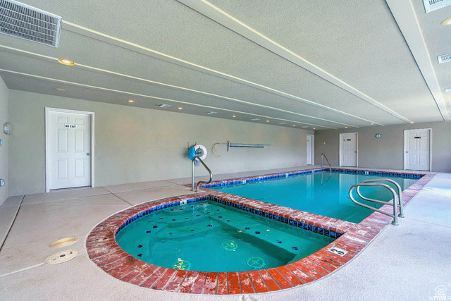 Community pool featuring an indoor hot tub