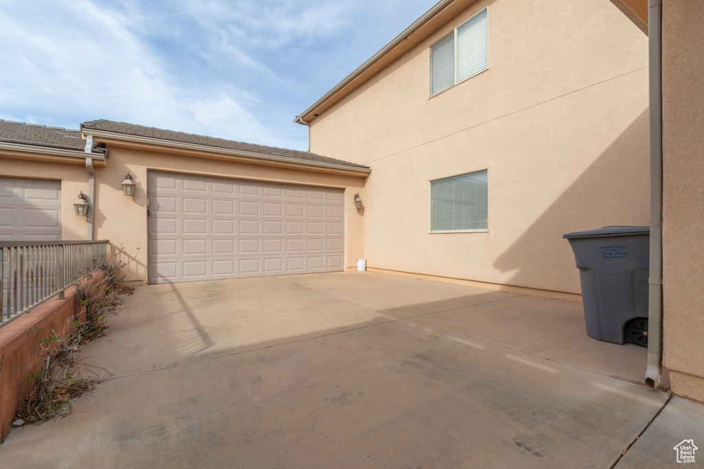 Exterior space featuring driveway and fence