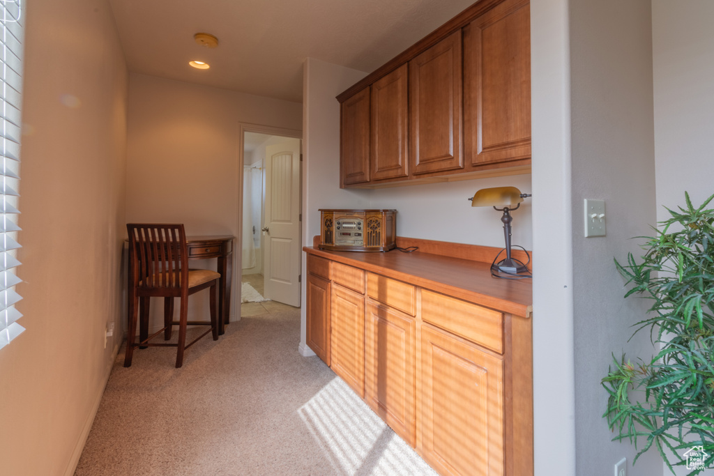 Interior space featuring light colored carpet and baseboards