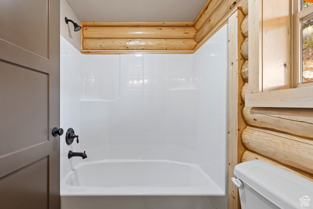 Bathroom featuring shower / tub combination and toilet