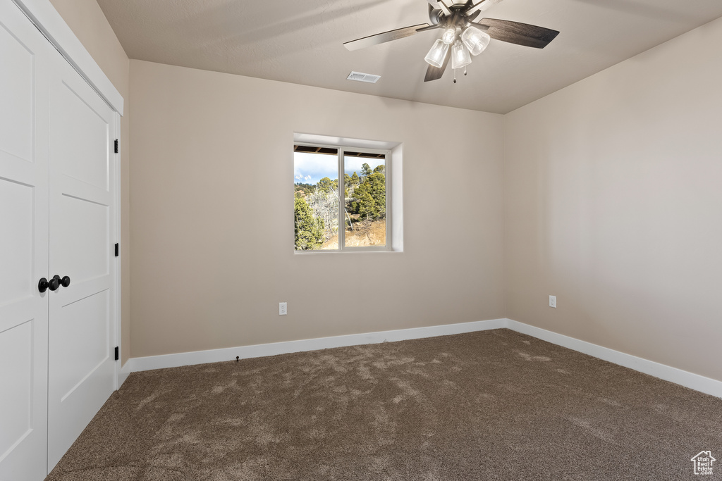 Unfurnished bedroom featuring carpet floors, a closet, visible vents, and baseboards