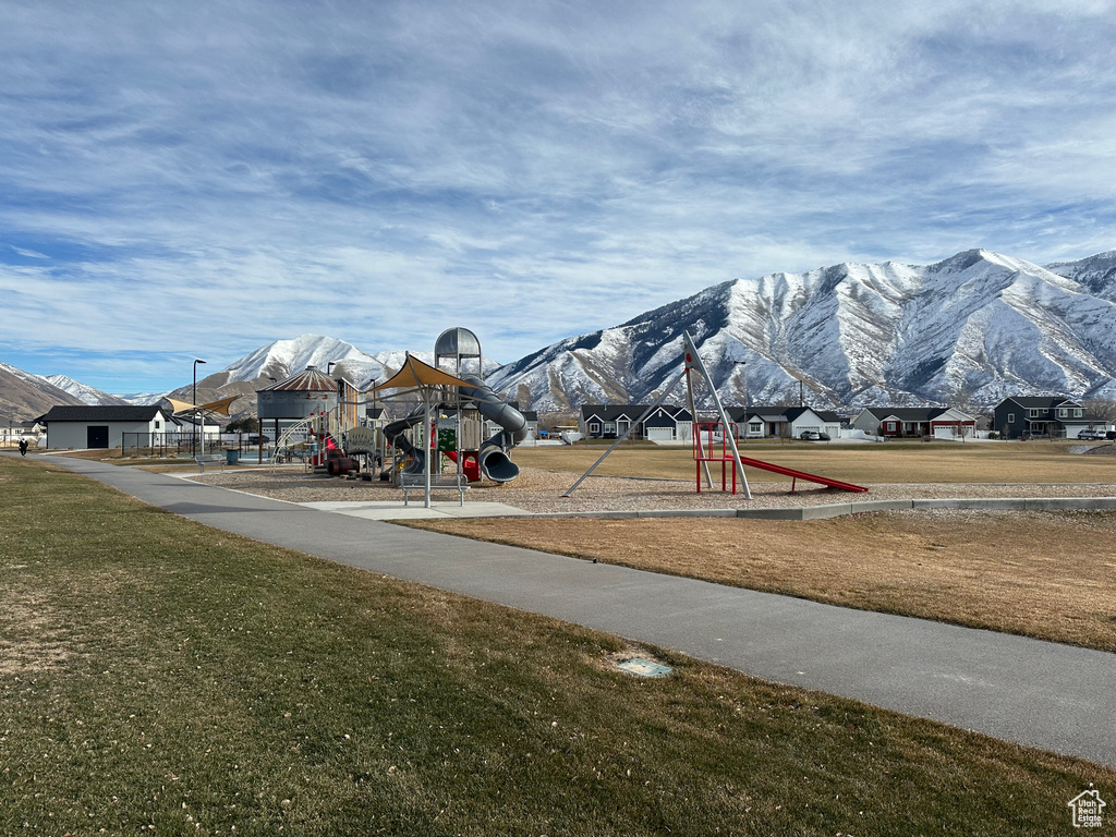 Communal playground with a yard and a mountain view