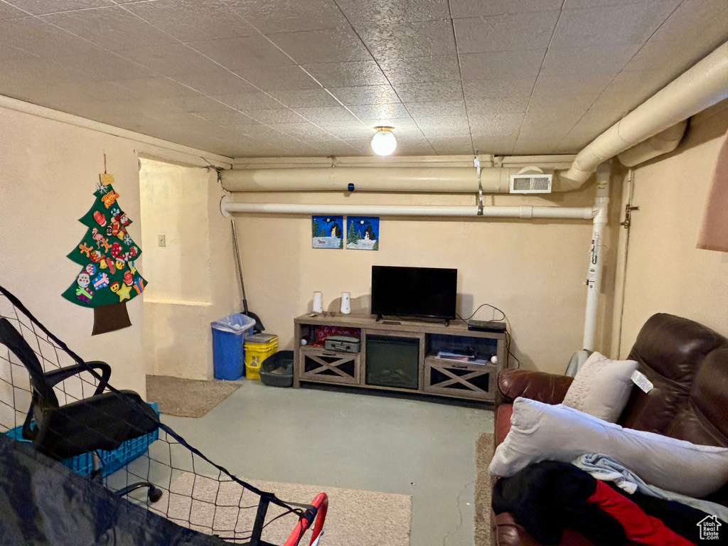 Living area with concrete floors and visible vents