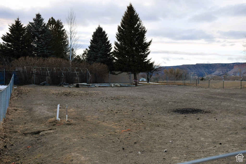 View of yard with fence and a mountain view