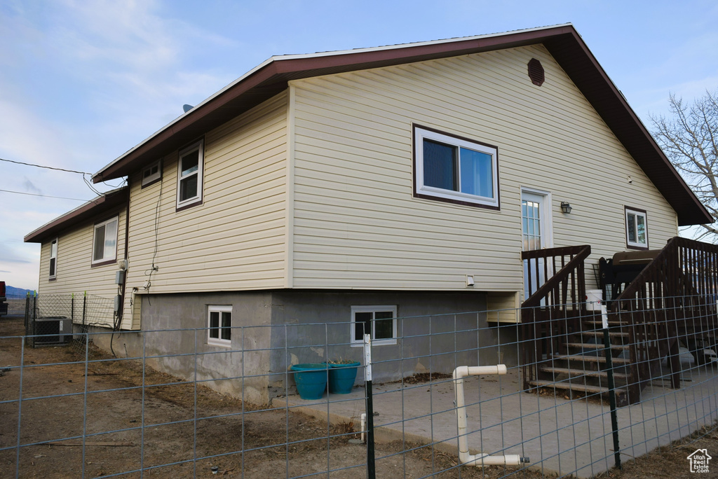 View of property exterior featuring fence