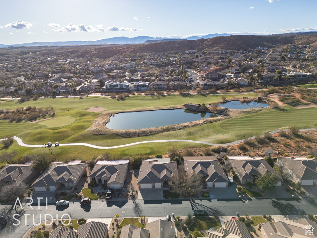 Aerial view of property's location with nearby suburban area, a golf club, and a water and mountain view
