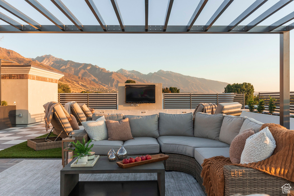 View of patio featuring an outdoor hangout area and a pergola