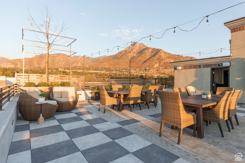View of patio / terrace with an outdoor hangout area, outdoor dining area, fence, and a mountain view