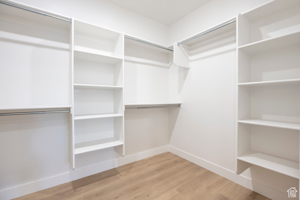 Walk in closet featuring wood finished floors