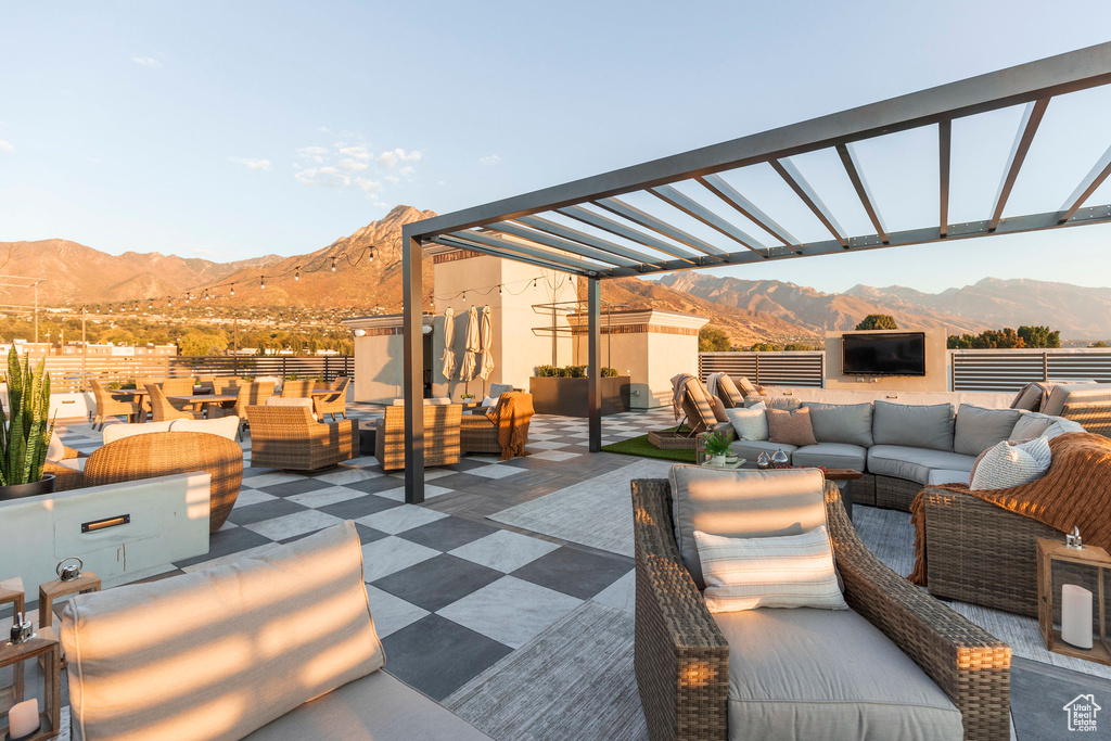 View of patio with an outdoor living space and a pergola