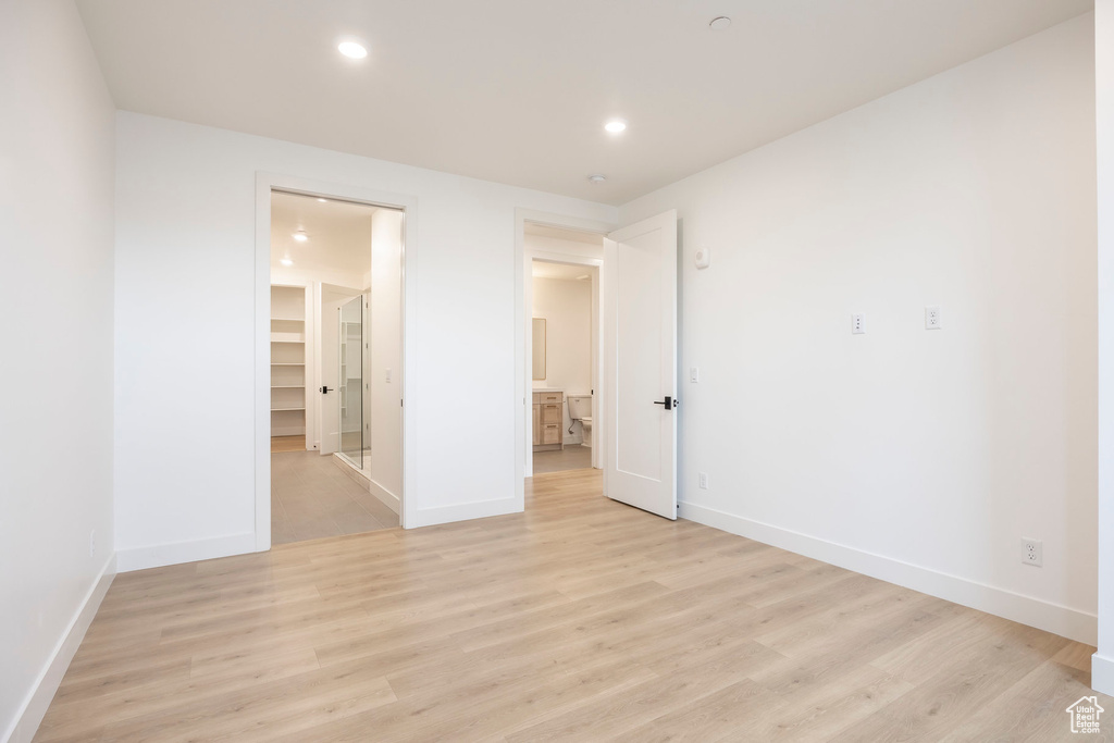 Empty room featuring recessed lighting, baseboards, and light wood finished floors