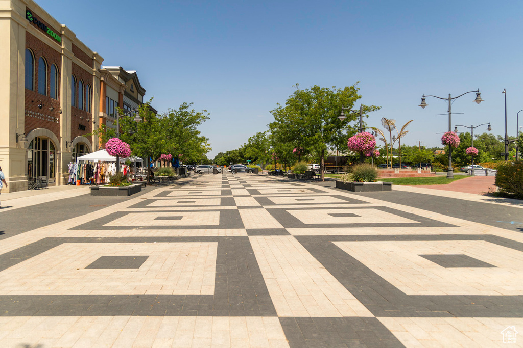 View of road featuring curbs, sidewalks, and street lights
