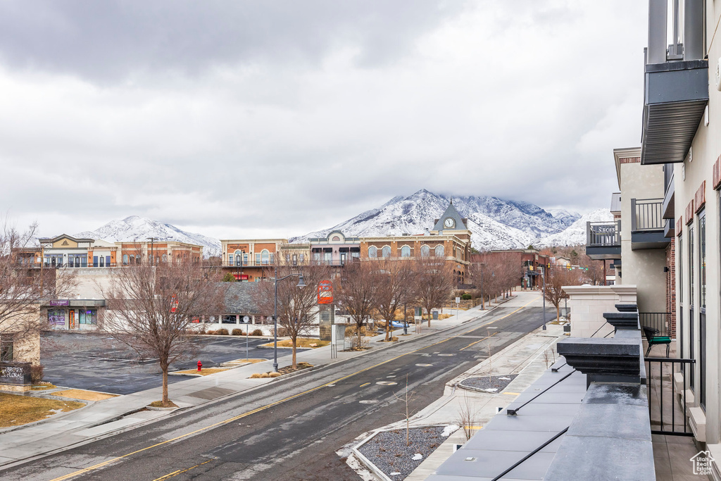 View of road featuring curbs, sidewalks, and a mountain view