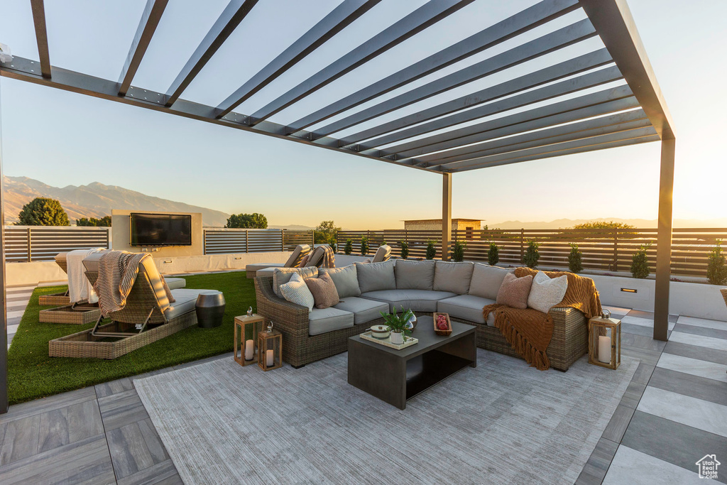 View of patio / terrace featuring fence, outdoor lounge area, and a pergola