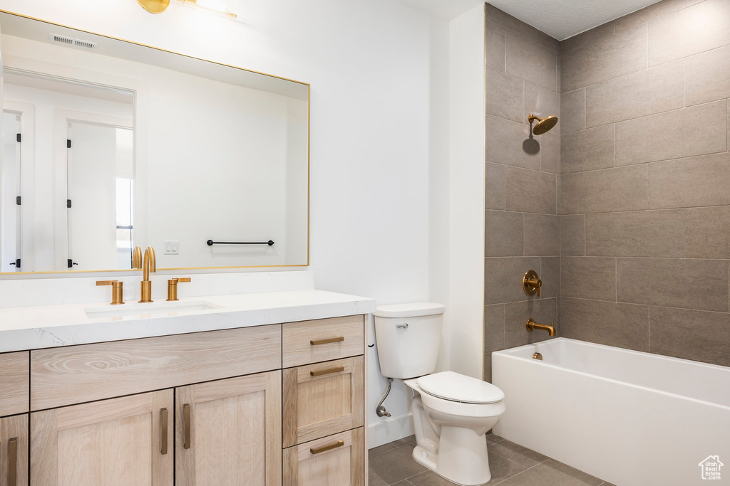 Full bath with shower / bathtub combination, visible vents, toilet, vanity, and tile patterned flooring