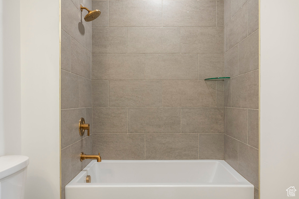 Full bathroom featuring tub / shower combination and toilet