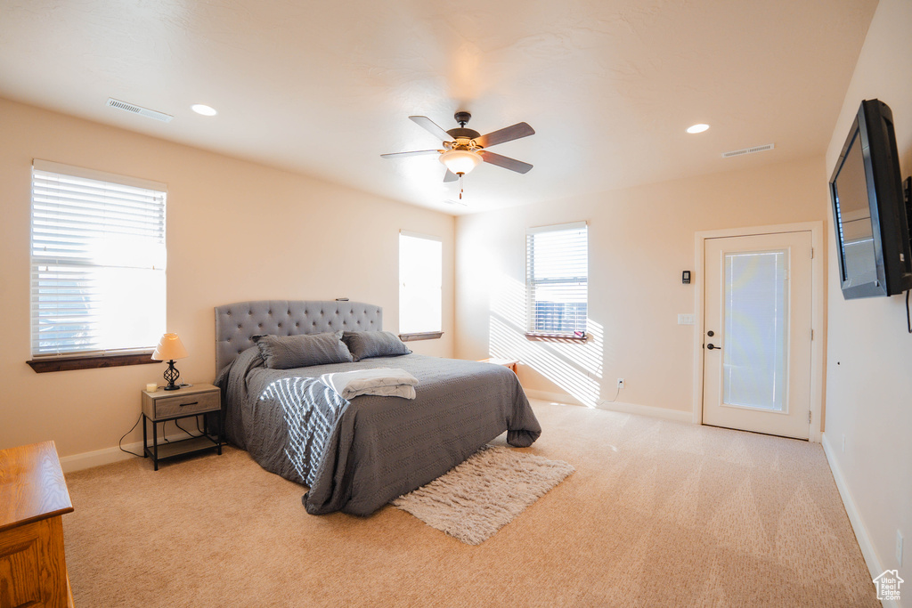 Bedroom featuring light carpet, visible vents, and baseboards