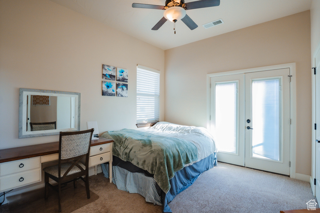 Carpeted bedroom with access to outside, french doors, visible vents, and a ceiling fan