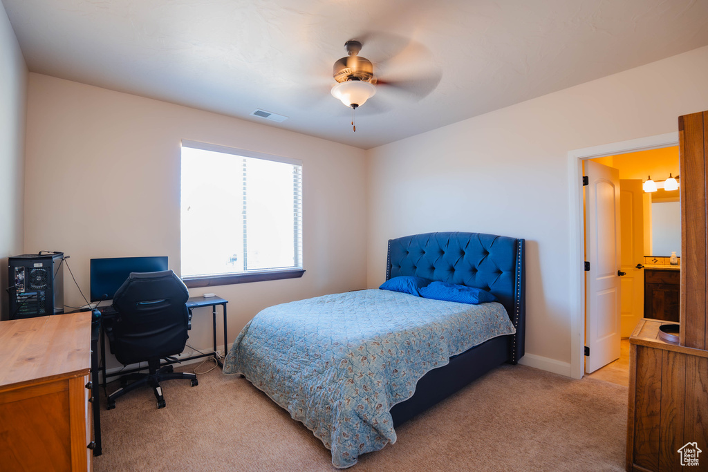 Bedroom featuring visible vents, ceiling fan, light carpet, and baseboards
