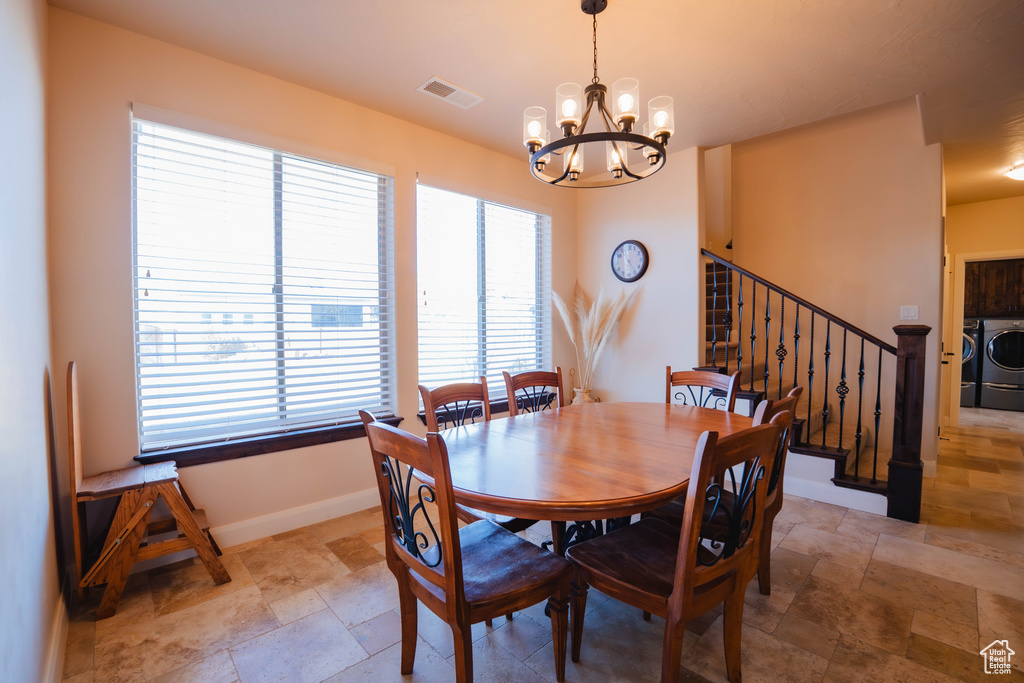 Dining space featuring visible vents, baseboards, stairs, washer and dryer, and stone finish floor