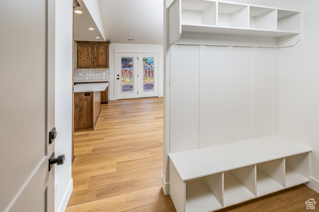 Mudroom with recessed lighting and light wood-style floors