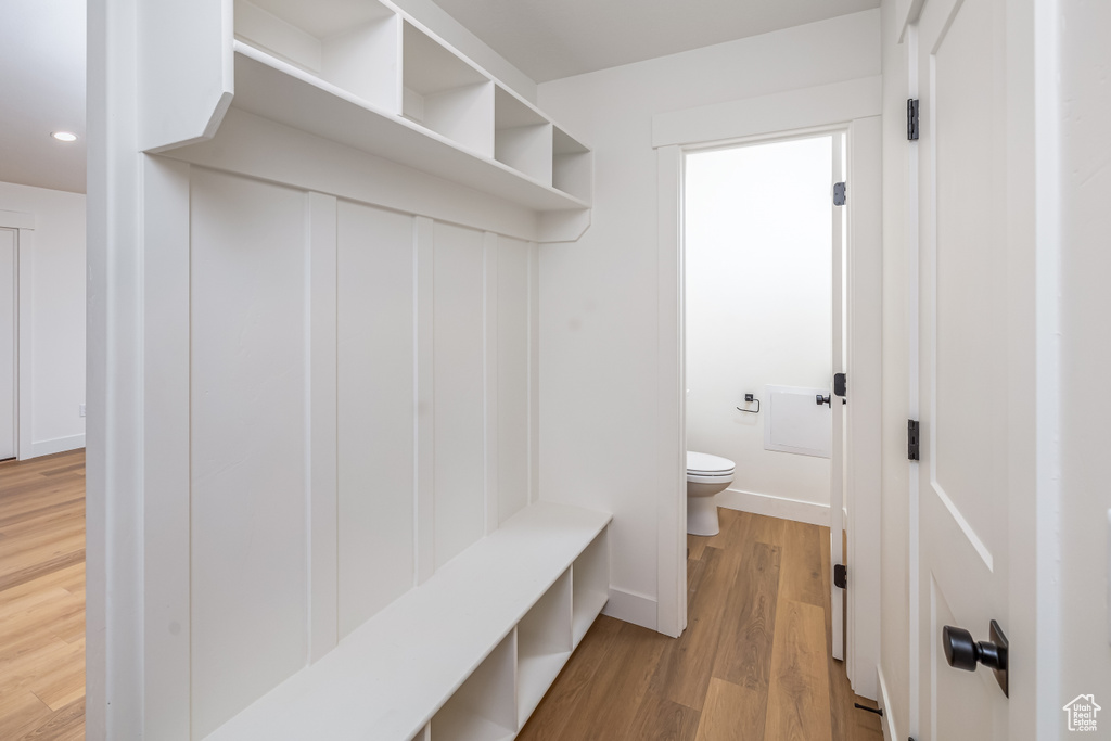 Mudroom with wood finished floors and recessed lighting