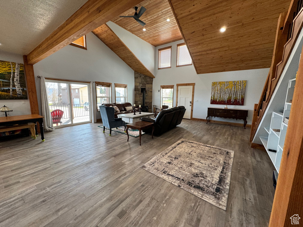 Living area featuring ceiling fan, high vaulted ceiling, wooden ceiling, and wood finished floors