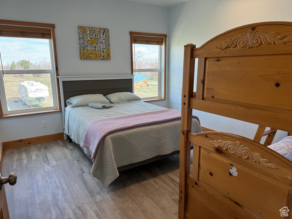 Bedroom featuring baseboards and wood finished floors